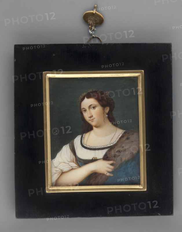 La Fornarina after Sebastiano del Piombo; Thil, Wilhelmine Louise du 1782–1819 painter; copy from Raphael's La Fornarina; portrait of a young woman, waist-high, facing left; miniature; foreign miniature; dated 1820; height 7.8 cm, width 6.4 cm; inscriptions/notes on provenance and repossession removed., A framed painted portrait of a woman is centered on a dark gray background; the frame consists of a wide black outer border with a narrow gold inner trim and a small metal hanging loop at the top. The portrait shows a woman with fair skin and brown hair styled with small curls and a decorative headpiece, wearing a white blouse with puffed sleeves and a blue bodice edged with dark trim; she has a fur or brown shawl draped over one shoulder and is shown from the torso upward with one hand resting on the shawl. The visible colors include black, gold, dark gray, white, blue, brown, and flesh tones.
