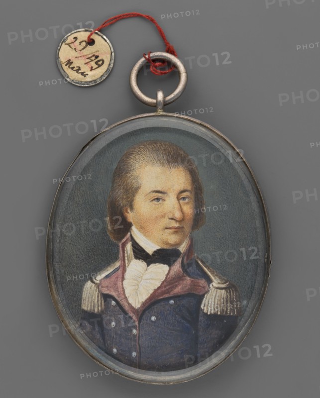 Portrait of the young General Jan Henryk Dabrowski 1755–1818 in uniform based on an image from the palace in Winnogóra Winna Góra, unknown artist, three-quarter portrait. Subject: men, male portrait, soldier, commander of the Napoleonic campaigns 1795–1815, Duchy of Warsaw 1807–1815. Insignia: Order of the White Eagle, Virtuti Militari. Pose: bust left, head turned right. Appearance: brown hair smoothly combed back from forehead and temples; blue eyes; white shirt collar and jabot; black cravat; navy blue uniform with magenta lapels and collar, silver buttons and epaulettes. Background: dark gray. Technique/format: miniature; silver rim set on two beveled crystal glass plates, binding shared with another miniature; height 6.1 cm, width 5.0 cm. Date: 1810. Place of origin: Poland. Provenance unknown., An oval pendant with a painted portrait of a man wearing a dark blue military-style coat with a high collar and epaulettes, a white ruffled shirt, and a black cravat, set against a muted g...