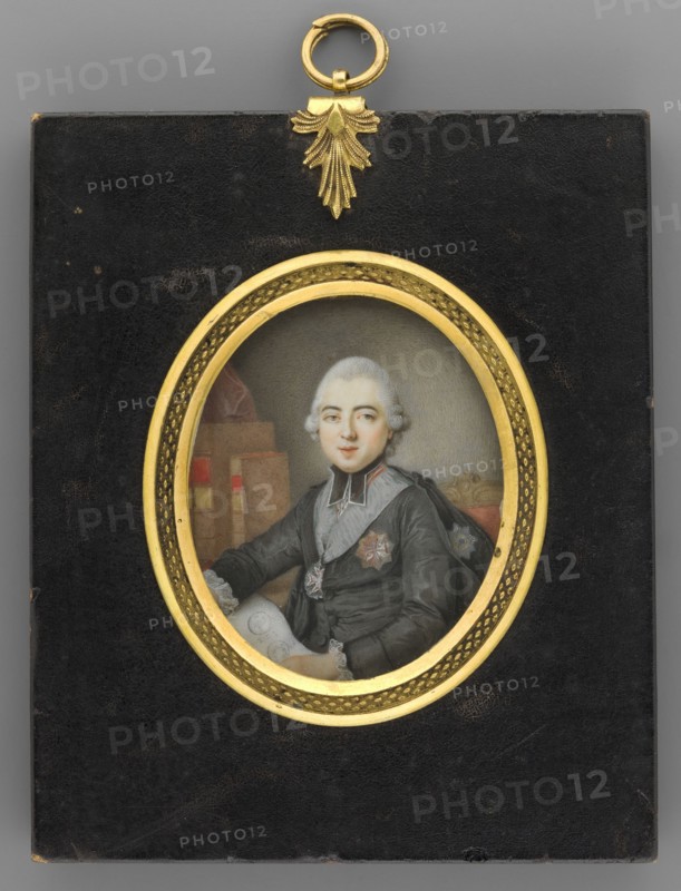 Portrait of Primate Michal Poniatowski 1736–1794 with plans for the construction of the palace rotunda in Jablonna, unknown artist, clergy, aristocracy, men, orders, interiors, politicians, three-quarter portrait, Polish miniature, portrait of a man. Half-length, seated with a sheet of parchment in his hands, in black clerical robes, around his neck the Order of the White Eagle and Order of St. Stanislaus; on the right two order stars. Background ash-gray, lightened around the head. On the reverse in black ink at the top: Ignacy Massalski / Bishop of Vilnius. Previously believed to depict Ignacy Massalski 1727–1794; the miniature combines elements from two oil compositions showing Primate Michal Poniatowski, including one with plans for the rotunda of the palace in Jablonna. 1780, Poland. Miniature; height 6.0 cm, width 5.1 cm. Binding: oval frame of gilded bronze on a flat rectangular board of ebony-stained wood, decorative grip., A framed oval portrait set in a rectangular black back...