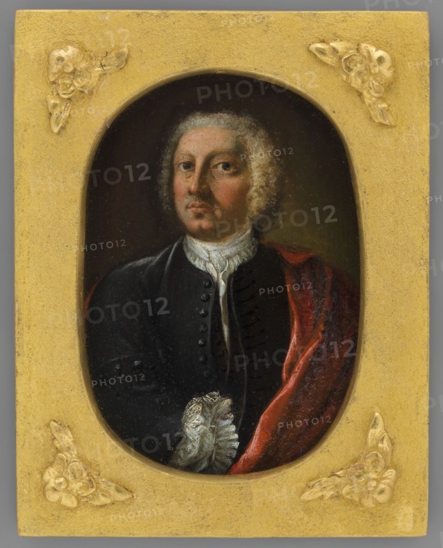 Portrait of an Unknown Man. Pawel Karol, Prince Sanguszko? 1680–1750, unknown painter; en face male portrait, costume; miniature; 1750–1800; height 11.0 cm, width 7.9 cm., An oval portrait of a man with pale skin and light curly hair set within a rectangular gold frame decorated with raised floral motifs; the man wears a dark coat with a high white ruffled collar and a red draped cloth over one shoulder, and his expression is neutral while his gaze faces forward against a dark background, with visible colors including gold, black, red, white, pale flesh tones, and hints of brown and gray.