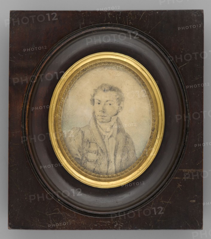 Self-portrait of the Artist, Rogozinski, Antoni Wincenty 1797–1835. Miniature, 1832. Three-quarter-length self-portrait of a young man, oval face, short wavy hair, long sideburns, upturned nose, turned left. He wears a coat decorated with braiding over a dark frock coat with a high collar, white shirt, scarf, and vest. Grey-bluish background. Oval profiled light brass frame decorated with a row of stylized engraved palmettes, set in a rectangular profiled frame of brown-stained ash wood. Dimensions: height 6.4 cm, width 5.2 cm., self-portrait, male portrait, painters, costumes, hairstyles, Polish miniature., A framed oval portrait set in a rectangular wooden plaque, with a dark brown wooden outer panel and a circular recessed inner molding in a darker brown, surrounding a gilded oval inner frame; inside the gilded frame is a faded pencil or graphite sketch of a young man wearing a jacket and scarf, drawn in soft gray tones with pale beige paper background and slight greenish shading ar...