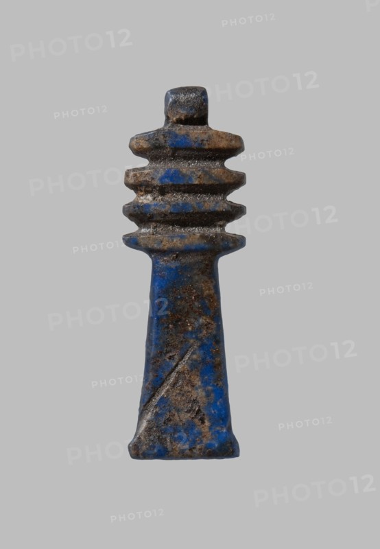 Amulet - djed pillar. Djed pillar with four crossbars, decorated on both sides; pendant on top. Late Period–Ptolemaic period, 7th–1st century BC, Egypt. Material: amulet. Dimensions: height 2.5 cm, width 0.8 cm., A single, vertically oriented object with a tapered base and a stacked, ridged top is centered on a plain gray background; the object shows a mottled surface with prominent blue and brown tones, darker brown patches and some lighter worn areas, and a textured, slightly rough appearance with uneven edges and small pits.