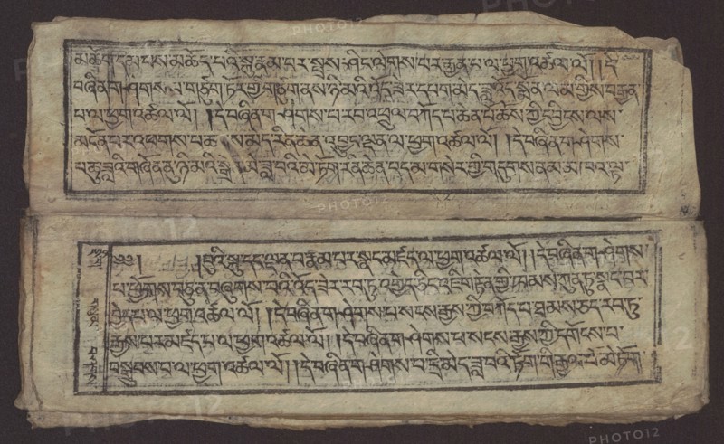 Buddhist text - Formula of repentance Tib. sdig bshags gser gyi spu gri bzhugs so, unknown author, Buddhist art, Tibetan, graphic prints, Book in the Tibetan pecha style, xylographic print in the disciple script dbu can, 16 folios, folio numbering 2-15 recto, first verso, print on thin handmade paper with clear translucency, 19th century, Tibet, graphic, width 25.5 cm, height 7.8 cm, A worn rectangular sheet with a dark background shows two horizontal framed panels separated by a narrow blank space; the upper panel is positioned toward the top edge and the lower panel toward the bottom edge, each framed by thin dark lines and containing dense dark markings that form repeating linear patterns. The paper has an aged, uneven texture with visible creases and slight tears along the edges, and areas of darker discoloration and faint smudging. The dominant colors are beige and tan of the paper, dark brown to black of the framed lines and markings, and hints of gray and faded brown in the worn...