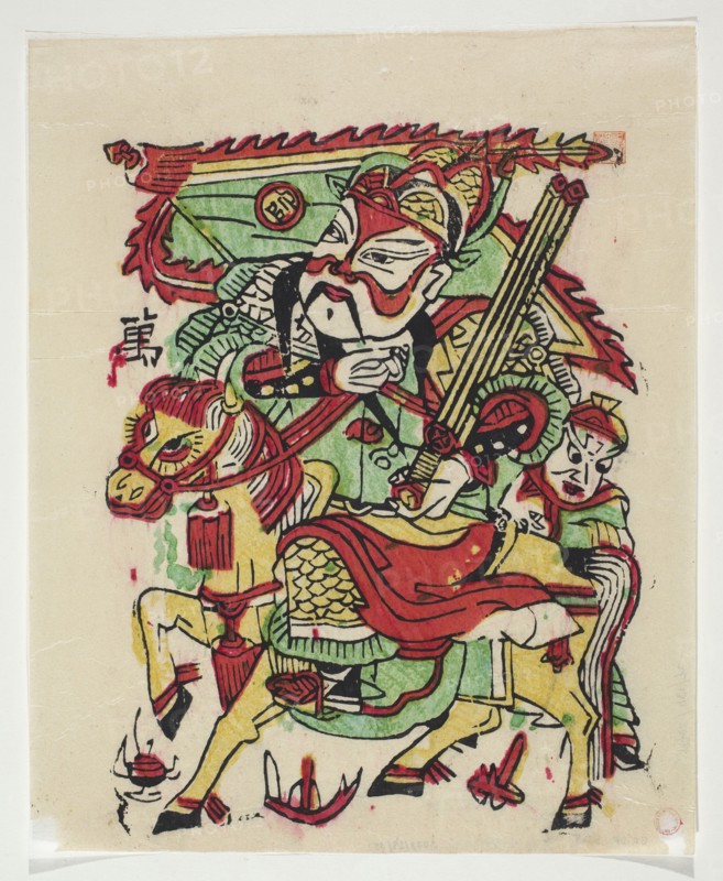 Menshen gatekeeper depicted on horseback, nianhua New Year picture, graphic print, early 20th century, Chinese; height 30.0 cm, width 24.5 cm., A colorful painted scene shows a stylized figure wearing ornate headgear and a mask-like face, holding a long instrument or staff, seated on a horse with decorative tack; a second smaller figure appears behind the rider. The composition uses prominent red, green, yellow, black, and some pink tones, with bold black outlines and areas of layered color. The horse has a flowing mane and decorative tassels, and the rider wears patterned armor or clothing with scale-like and striped details. There are decorative flame-like shapes and ribboned elements around the figures, and the background is a pale beige or off-white paper. The overall style is bold and graphic with visible brush and print marks.
