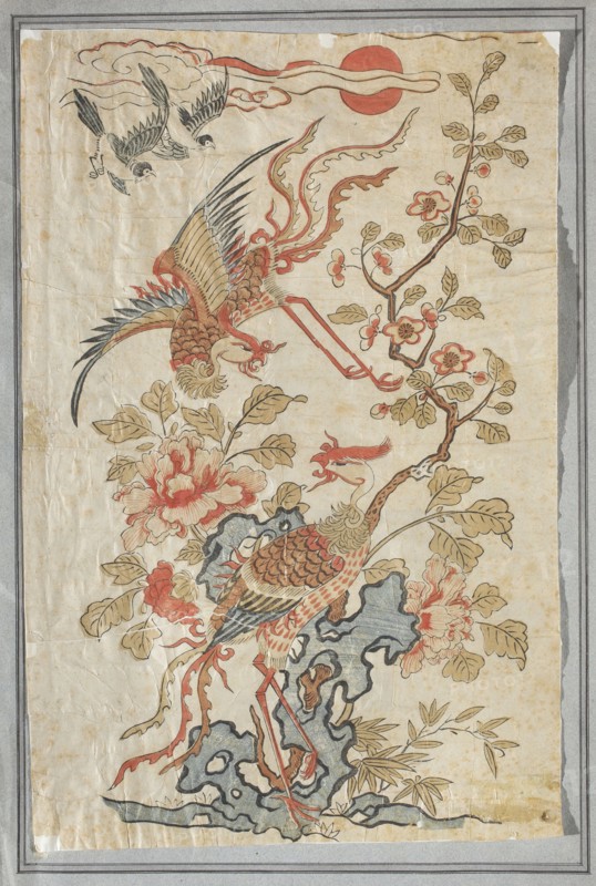 A pair of fenghuang phoenix birds; unknown creator; Chinese art; Chinese culture; visual documentation; fenghuang/phoenix iconography; On the left at the top of the strip of small birds there is a New Year's picture; early 20th century, China; graphic print; height 44.0 cm, width 28.0 cm., An aged vertical artwork shows a stylized scene with a large ornamental bird with long legs and an elaborate tail standing on a textured rock formation, a second large bird in flight above with outstretched wings, and a pair of smaller birds flying near the top; several flowering branches with blossoms and leaves surround the birds, along with large peony-like flowers and scattered foliage. The palette includes muted reds, warm browns, pale yellows, soft greens, blue-gray for the rock, black outlines, and areas of off-white and beige from the aged paper. The composition is framed by a thin border and the paper shows creases and worn edges.