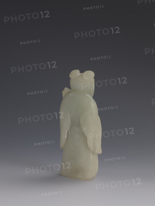 One of the Eight Immortals, Eight Immortals iconography, men, Chinese art, fans, Chinese culture, Qing 1644–1911, 19th century, China, sculpture, height 14.3 cm, width 5.9 cm, A pale greenish-white carved stone figure is shown from the back against a dark gray to muted bluish-gray gradient background, with the figure standing on a lighter gray surface; the figure has a smooth rounded head with two coiled bun shapes, gently sloped shoulders, long draping sleeves or wing-like extensions, and a long robe with faint carved curved lines, and the visible colors are pale greenish-white, dark gray, bluish-gray, and light gray.