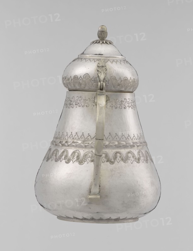 Teapot, teapot, Turkish, Ottoman dynasty 1299–1922; 19th century, Turkey; vessel; materials not specified; weight 320 g; height 17.0 cm; diameter 10.9 cm; decorative motifs: geometric motifs, plant ornament, zigzag, lambrequin., A pear-shaped metal vessel with a domed lid and a hinged handle is shown against a plain light gray background, displaying a reflective silver color with areas of darker patina and light wear; the lid has a rounded finial and a scalloped band at its base, the upper body features ornate engraved decorative bands and a repeating scallop motif, the midsection shows a braided or rope-like raised band and additional etched patterns, the handle extends vertically from near the lid to the lower body and appears slightly tarnished with visible joins, and the surface overall has a smooth metallic texture with subtle dents, scratches, and variations in sheen.