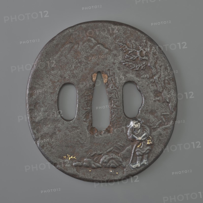 Crossguard tsuba, Kaneie craftsman, 18th century Edo Period, 1603–1868, Japan; Fushimi, Yamashiro province. Oval tsuba tatemaru gata with rounded edge maru mimi; height 8.0 cm, width 7.4 cm, depth 0.4 cm. Both sides decorated in relief landscape with figures: obverse shows a wanderer with two calabashes at his belt and a stick standing by a mountain stream — details face, hands, bottles, binding inlaid with silver, gold, and copper; reverse depicts a fisherman in a boat by a bamboo-covered shore with minor accents inlaid with gold. Subjects: landscape motifs, rocks, trees, bamboo, water, fishermen, boats, sea waves; weapon type: sword crossguard tsuba for katana., A round, dark brown metal object with a textured surface and a few areas of lighter gray patina, featuring a central elongated opening flanked by two oval openings; near the lower right edge there is a small, raised figure in silvery-gray with darker brown accents and touches of gold on small details, and a raised rocky forma...