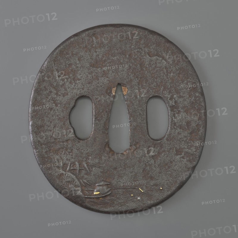 Crossguard tsuba, Kaneie; craftman/school. Oval tsuba tatemaru gata with rounded edge maru mimi. 18th century Edo Period, 1603–1868, Japan — Fushimi, Yamashiro province. Iron tsuba, height 8.0 cm, width 7.4 cm, depth 0.4 cm. Both sides decorated in relief with landscape motifs and figures: obverse shows a wanderer with two calabashes at his belt and a stick standing by a mountain stream; some details face, hands, bottles, binding inlaid with silver, gold, and copper; reverse depicts a fisherman in a boat by a bamboo-covered shore with minor accents inlaid with gold. Subjects: rocks, trees, bamboo, water, fishermen, boats, sea waves; function: sword crossguard katana tsuba., A round, flat metal object with a weathered, textured surface in dark brown and gray tones sits against a smooth gray background; the object has a central elongated cutout flanked by two rounded cutouts, and shows areas of lighter gray patina and small patches of reddish-brown rust, along with a few small accents of...