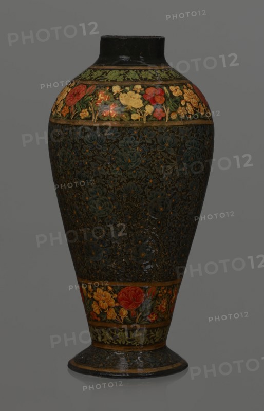 Vase, Qajar dynasty 1785–1925, Islamic art, Persian; lacquer vase, 19th century, Iran. Vessel, height 32.0 cm, diameter 17.0 cm. Decoration: densely placed plant motifs peonies with gold contouring; on the collar and above the foot flowers red and gold. Inside a card no. 54 with an inscription in Italian noting it is a lacquer vase., A tall vase with a rounded body tapering to a narrow base and short neck, featuring an overall dark background with intricate floral patterns; a band near the top and another near the base show brightly colored flowers in red, yellow, orange and green, while the central body area has a dense, textured floral design in deep green and dark tones with small accents of muted gold; the neck and foot rim are dark, and the image background is a neutral gray.