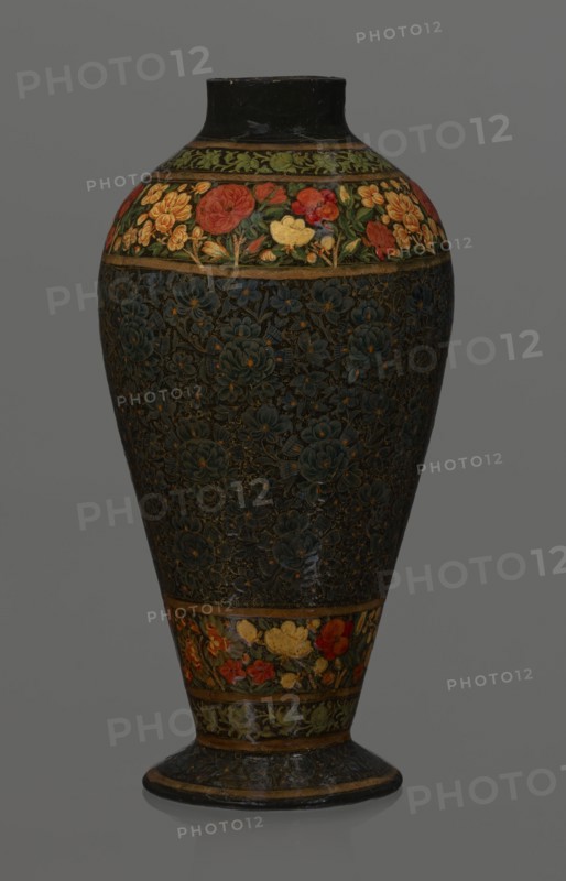 Vase, Qajar dynasty 1785–1925, Persian, 19th century, lacquer vase. Decoration: densely placed plant motifs peonies with gold contouring; collar and above the foot decorated with flowers red and gold. Inscription Italian on inner card noting it is a lacquer vase. Vessel; height 32.0 cm, diameter 17.0 cm., A tall vase with a rounded body tapering to a narrower foot, decorated with floral bands and a dark central field; the top and lower bands show a group of stylized flowers in red, yellow, orange, green, and hints of blue against a dark background, separated by narrow goldish borders; the central area is predominantly dark with an embossed or painted pattern of flowers in deep blue and muted gold tones creating a textured appearance; the neck and base rim are dark, with touches of goldish trim, and the overall color palette includes black, dark blue, green, red, yellow, orange, and goldish accents.