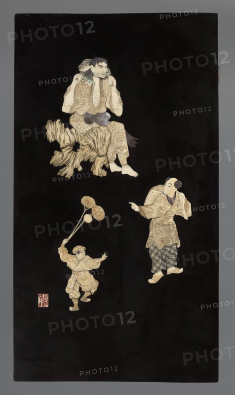 Panel, Japanese art, Japanese, Meiji 1868–1912, panels, toads, rocks, children, frogs, asanoha pattern, shippo pattern, boys, 19th/20th century, Japan, sculpture; height 75.0 cm, width 42.0 cm, depth 3.0 cm, A vertical rectangular panel with a deep black background shows three ivory-toned figures and a carved wooden element arranged vertically; near the top a seated figure with pale skin and dark hair wears patterned garments in beige and tan with a dark sash and sits on a textured, wood-colored formation; lower and to the right a standing figure with a pale face and shaved hair wears layered beige and tan patterned clothing with darker patterned trousers and light-colored footwear and holds a rounded woven object on the back while pointing; lower and to the left a smaller figure with pale skin and dark hair in beige and tan clothing is animatedly leaping while holding a group of round beige objects on thin dark stems; the overall palette includes black, beige, tan, light brown, dark b...