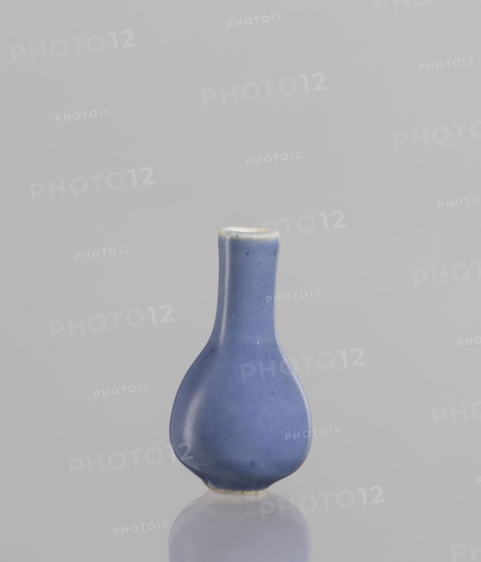 Bottle, Chinese, 19th century, blue-and-white porcelain poudre bleu, ceramic vessel, height 5.3 cm., A small rounded vase with a narrow neck and bulbous body in a blue color with subtle darker speckles, set against a light gray background with a soft reflection beneath it; the rim shows a hint of off-white and the base has a touch of beige.