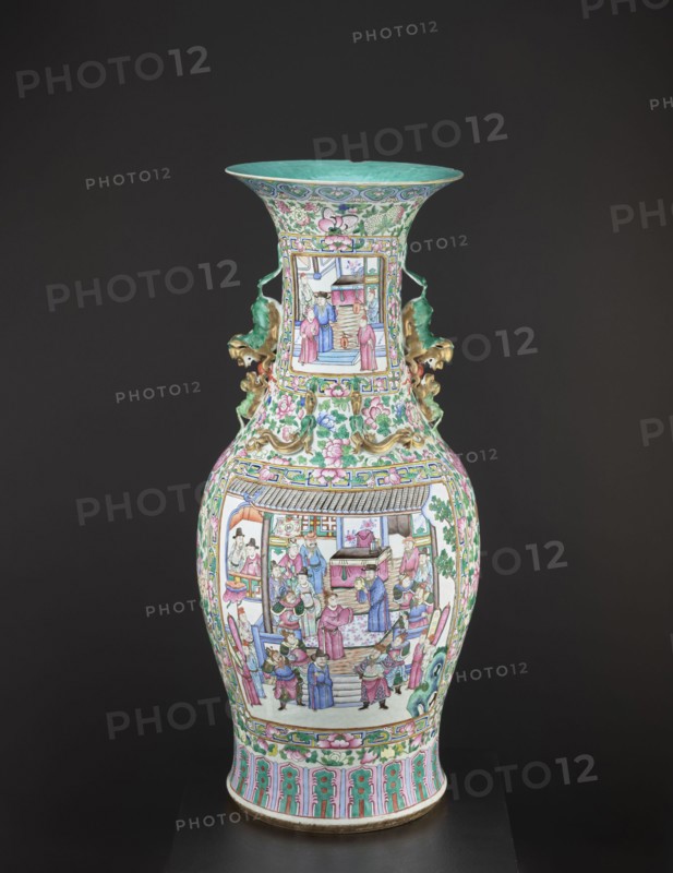 Vase, lion iconography, protection, court scenes, ceramics, Qing style, colored porcelain, Chinese art, Chinese culture, decorative vessel, Qing 1644–1911, rim covered with turquoise paint on the inside, 19th century Qing dynasty, China, vessel, height 90 cm, diameter 37.5 cm, A tall, ornate porcelain vase sits against a dark background, decorated with intricate painted scenes of people in traditional dress on its bulbous body and narrower neck, with floral and scroll motifs surrounding the panels; the vase features ornamental handles shaped like stylized creatures in a greenish hue with gold accents, and the rim and interior of the flared mouth are a turquoise-green; the painted figures and architectural elements show a palette of pink, green, blue, purple, and white with accents of gold and black outlining, while the lower foot band displays repeating vertical patterns in turquoise-green and pink framed by green foliate borders.