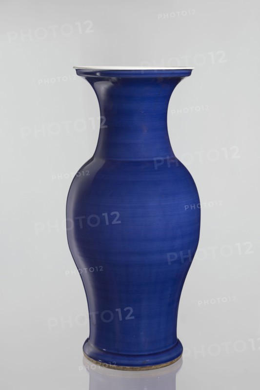 Vase, Chinese, decorative vessel, Qing style Qing dynasty, 1644–1911, ceramic, 19th century, China; vessel; height 62.5 cm, diameter 28.5 cm, A smooth vase with a curving silhouette in a deep cobalt blue finish, displaying subtle horizontal banding and variations in tone, with a slightly flared rim that has a thin lighter edge and a rounded base that sits on a narrow foot ring showing a muted metallic accent; the background is a soft pale gray.