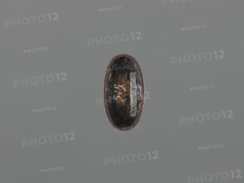 Sword hilt cap kashira, ; subject: deer and Fukurokuju deity; Japanese, Edo period 18th century, 1603–1868; function: kashira for swords/katana saber hilt; materials/objects: sabers, hilts; dimensions: height 3.4 cm, width 1.8 cm, depth 0.8 cm., An oval, bowl-like object with a rough, uneven interior sits against a plain gray background; the object shows dark black and deep brown tones inside with areas of rust-colored brown and lighter gray along the rim, and the outer edge appears reddish-brown.