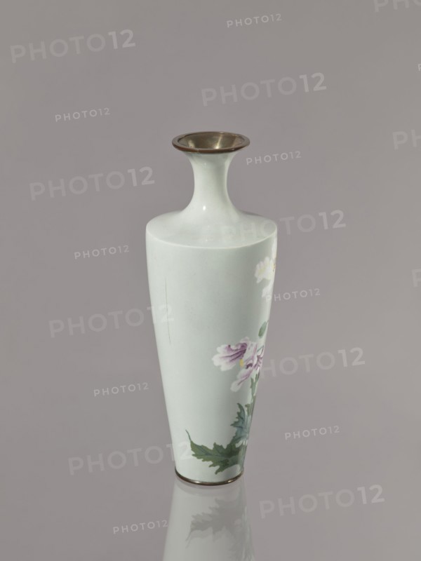 Vase, poppies and flowers iconography; Japanese; Meiji–Taisho period, ca. 1910–1920; cloisonné enamel; Nagoya, Japan; vessel; height 24.5 cm, diameter 9.0 cm., A slim, pale green ceramic vase with a narrow neck and a flared rim that has a metallic brownish-gold inner edge, decorated with painted flowers in shades of pink, white, green, and hints of yellow, set against a smooth grayish background with the vase casting a faint reflection.