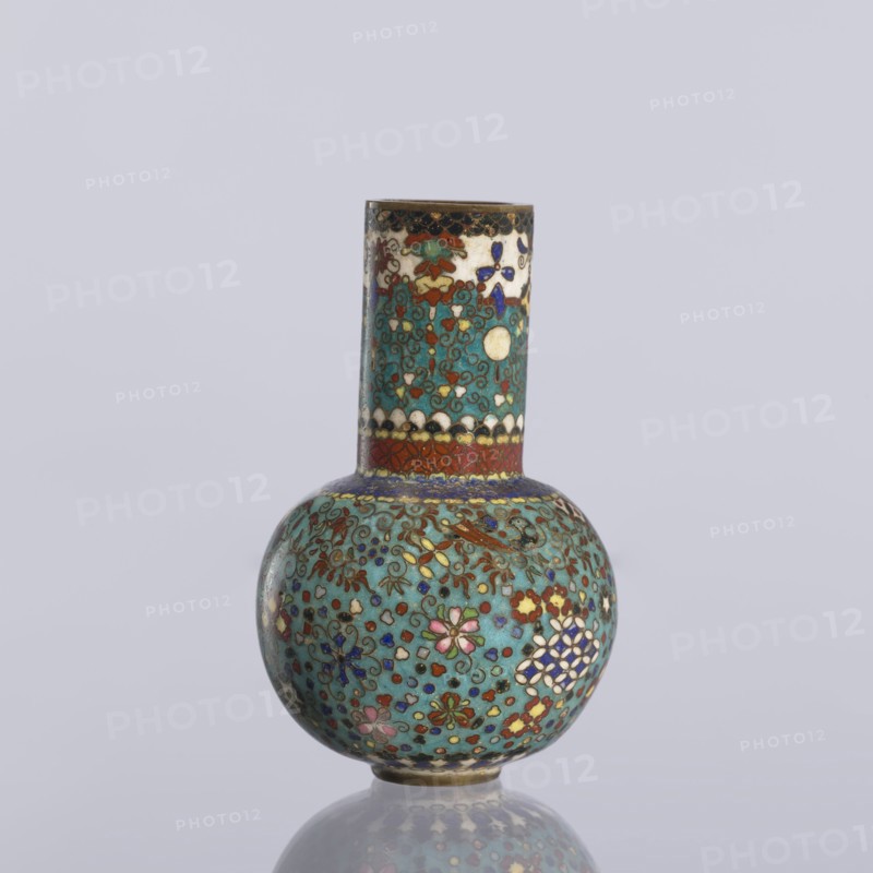 Vase, gift, Japanese art, Japanese, Meiji 1868–1912, geometric decorations, vases, decorative vessels, cloisonné enamel. Vase with a spherical belly and a long cylindrical neck decorated on the entire surface with small floral and geometric motifs on a turquoise background, ca. 1880 Meiji Period, 1868–1912, Japan, Nagoya. Vessel; height 9 cm, diameter 5.7 cm., A small bulbous vase with a tall cylindrical neck, covered all over in intricate cloisonné patterns in turquoise, teal, green, red, blue, white, pink, purple, gold, and black; the neck shows a banded design with scalloped motifs and floral elements while the round body features a dense arrangement of stylized flowers and scrolling vines with highlights of gold; the vase sits on a reflective surface and is set against a pale gray background.