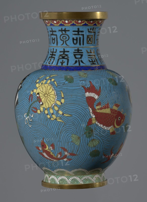Vase, 19th century, China. Cloisonné enamel vase on a foot with a neck; height 23.5 cm, diameter 9.3 cm. Decoration: fish and crabs on a turquoise background, archaizing inscription on the neck. Qing dynasty style; Chinese art., A rounded vase with a flared neck and a metallic rim sits against a plain gray background; the vase surface is predominantly blue with swirling wave-like line patterns, decorated with red fish with white and yellow details, a yellow crab-like creature, several green leaves, and bands of decorative motifs in blue, green, red, gold, white, and black around the neck and base.