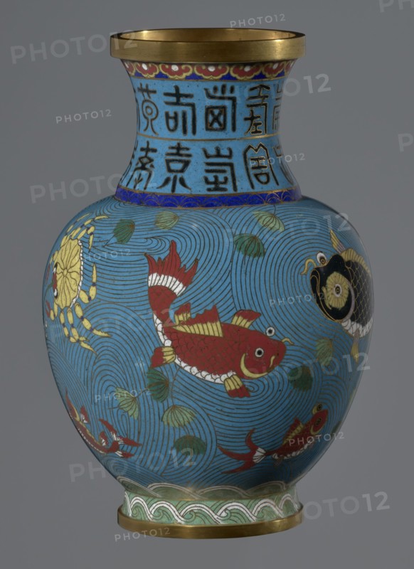 Vase, cloisonné enamel, Qing dynasty 1644–1911, 19th century, China. Vase on a foot with a neck; decoration of fish and crabs on a turquoise background, archaizing inscription on the neck. Height 23.5 cm; diameter 9.3 cm., A rounded vase with a narrow neck and flared gold rim, decorated with a bright blue background covered in swirling wave patterns and accented with green leaf-like shapes, featuring several stylized fish in red, black, and gold with white details, a crab in yellow and gold near one side, bands of decorative motifs in blue, green, white, red, and gold near the neck and base, and a gray backdrop behind the vase.