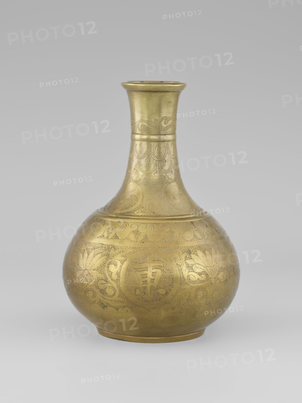 Vase - bottle; maker, 19th century; China, Qing 1644–1911. Porcelain vessel with plant ornament of peonies. Vase on a very low ring-shaped foot. Height 20.9 cm; diameter 15.38 cm., A rounded metal vessel with a narrow neck and flared rim sits against a neutral light-gray background; the vessel has a warm golden color with a subtle patina and is covered in finely incised decorative patterns including scalloped motifs and curved floral and foliate designs that wrap around the bulbous body and continue up the neck, with a few bands and textured detailing near the rim and base.