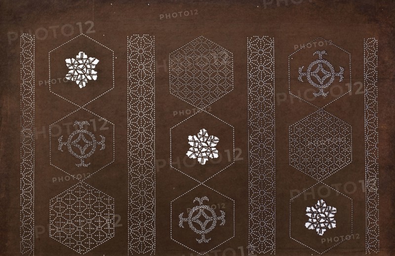 Katagami dyeing stencil with a striped motif of hemp leaves and hexagons asanoha to kikkô no shima moyô, ise-katagami, chuban format; geometric and plant patterns asanoha, kikkô. Pattern cut out on the pattern: in a striped arrangement, alternating octagons and borders with a stylised geometric and plant ornament., 2nd half 19th century Edo/Meiji period, Japan. Stencil; height 40.7 cm, width 26.0 cm., A dark brown background fills the image with a repeating vertical arrangement of hexagonal outlines formed by small white dots, creating a grid of hex shapes; inside several hexagons are intricate white decorative motifs that resemble floral or geometric rosettes, and inside others are patterned lattice designs made of white dotted lines. Between the columns of hexagons are vertical bands of repeating white dotted geometric patterns that look like flower-like star motifs. The visible colors are dark brown for the background and white for the dotted outlines and interior decorative element...