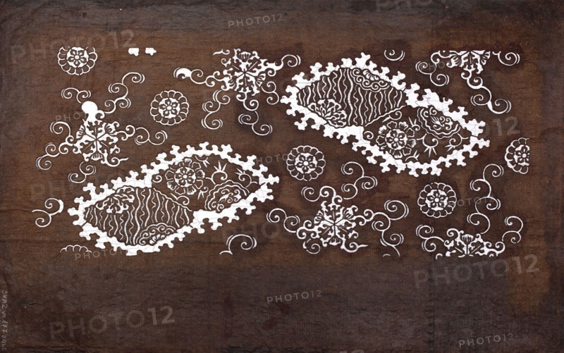Katagami dyeing stencil with a motif of stylized rhombuses with flowers and round floral motifs kawari bishi ni hana to hanamaru moyô, Meiji period 1868–1912, katagami stencil, chuban format, geometric-floral patterns, flowers, 19th–20th century Meiji period, Japan, stencil, height 41.0 cm, width 25.2 cm, The image shows a textured, mottled brown background with a series of ornate white decorative motifs scattered across it, including floral shapes, swirling curlicues, and two large leaf-like patterned clusters with scalloped edges; the white designs contrast with the various shades of brown in the backdrop.