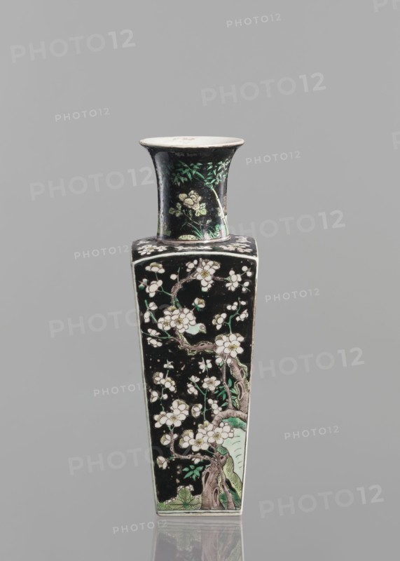 Pair of vases, Chinese, 18th century, Chinese ceramics, colored porcelain in famille noire palette, decorated with birds, plums, and floral motifs, vessel, height 22.5 cm., A tall, narrow vase with a flared rim and a square body decorated against a black background with a floral branch motif; the design shows pale blossoms and buds on twisting brown branches with green leaves and pale green accents at the base and on the neck, and the rim interior appears off-white while the exterior surface is predominantly black with touches of white, green, brown, and hints of pale yellow.