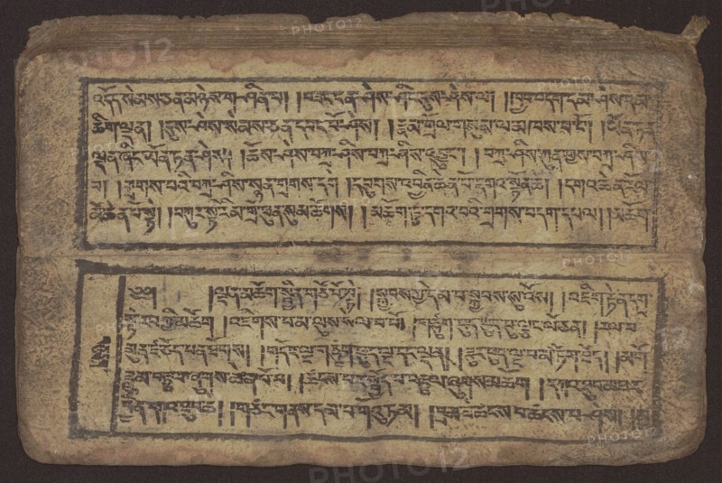 Buddhist text - Commentary on the praise of the names of Manjushri by Ga Rabjampa Kunga Yeshe Tib. 'phags pa 'jam dpal gyi mtshan yang dag par brjod pa zhugs so, unknown creator author, Buddhist art, Tibetan culture, graphic prints, Book in Tibetan pecha style, xylographic print in student script dbu can. 26 folios, recto page numbering, first verso, 2 pages missing. Buddhist commentary on the prayer of praise in honor of the names of the bodhisattva Manjushri Tib. 'jam dpal dbyang by Ga Rabjampa Kunga Yeshe Tib. sga rab 'byams pa kun dga' ye shes. The original text comes from the 15th century; object dated 19th century, Tibet. Graphics, width 24.6 cm, height 8.0 cm., An aged rectangular manuscript page with a worn beige surface and dark brown edges, showing two horizontal framed text blocks separated by a narrow blank band; the frames and dense rows of dark black ink markings create patterned lines across the page; the paper shows spots and smudges of brown and gray, with areas of dar...