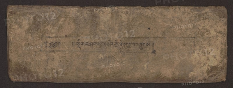 Buddhist Manuscript - Penitential Text Tib. sDig bshags gser gyi zhes bya ba bzhugs+o, unknown author/scribe, Tibetan Buddhist art, Himalayan culture, Book in Tibetan pecha style, manuscript in student's script. Leaf numbering 2–22 verso, first recto, last two unnumbered. Handwritten notes folio 24 recto and verso. 19th century, Tibet, manuscript, width 24.0 cm, height 8.1 cm, A worn rectangular object with rounded corners lying on a dark background, showing an uneven, textured surface with creases and scuffs; the surface displays a palette of brown, tan, beige, and muted gray-green tones with a few darker brown and black spots; faint rectangular border lines and a narrow horizontal band are visible across the central area, and within that band there is a row of dark, short vertical and curved marks; the edges appear slightly darker and more worn than the center, and there are areas of subtle discoloration and blotchy patterns across the entire surface.