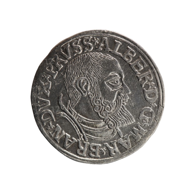 Trojak, Vogelwaider Vogelwaid, Eustachius mintmaster/publisher; Decius, Jost Ludwik fl. 1528–1535 mint manager/co-creator. Obverse: male bust in armour in profile facing right; short hair, beard with sideburns. Inscription around rim: *ALBER DG MAR BRAN DVX PRVSS. Continuous border, floral motifs between words. Reverse: inscription in six lines within continuous border: *III*/.GROSS:AR:/.TRIPLEX./.ALBER:DVC./.PRVSSIE./*I540* 1540. Ducal Prussia 1525–1701, Königsberg mint. Coin trojak: diameter 22.3 mm, weight 2.63 g, axis 90°., A circular metallic coin with a worn silver-gray surface showing a raised profile of a bearded man facing right, with textured hair and a detailed curled beard, wearing layered clothing or armor at the neck; the coin edge has a raised rim and a decorative band of raised elements encircling the portrait; the background is plain white.