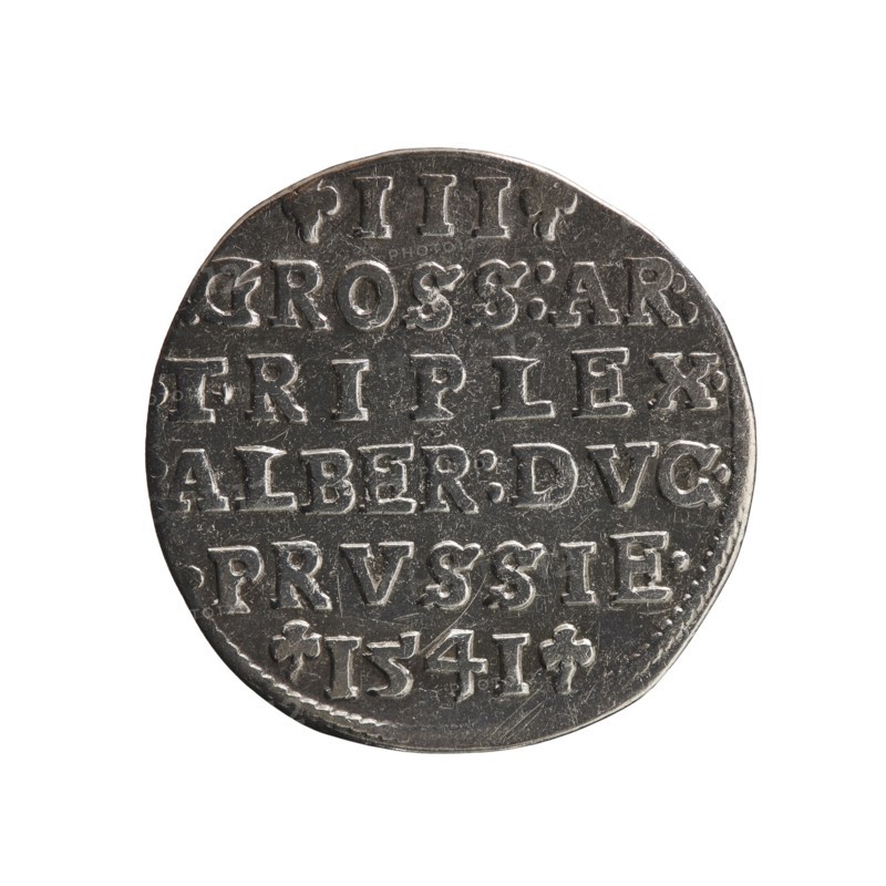 trojak; Schilling, Maciej mintmaster; Decjusz, Jost Ludwik fl. 1528-1535 co-creator; mint manager; Szymonski, Jan 1887-1954 maker; Albrecht Hohenzollern Prince of Prussia; 1490-1568 — iconography: trefoils, male busts in armour. Obv.: Male bust in armour in profile turned to the right; short hair, long beard with sideburns. In the rim an inscription beginning with a trefoil: -ALBER DG MAR BRAN DVX PRVSS pearl border, plant motifs between the words. Rev.: In the pearl border an inscription in six lines: -III-.GROSS:AR:/.TRIPLEX./ALBER:DVC./.PRVSSIE./-I54I- the denomination and date are between the trefoil marks. 1541. Ducal Prussia 1525–1701, Königsberg mint. Coin; diameter 22.7 mm; weight 2.64 g; axis 315°., A round metallic coin with a worn, textured surface shown against a white background, featuring raised lettering arranged in horizontal lines that cover most of its face; the coin appears silver-gray with darker gray areas in the recesses and lighter, slightly reflective highlights...
