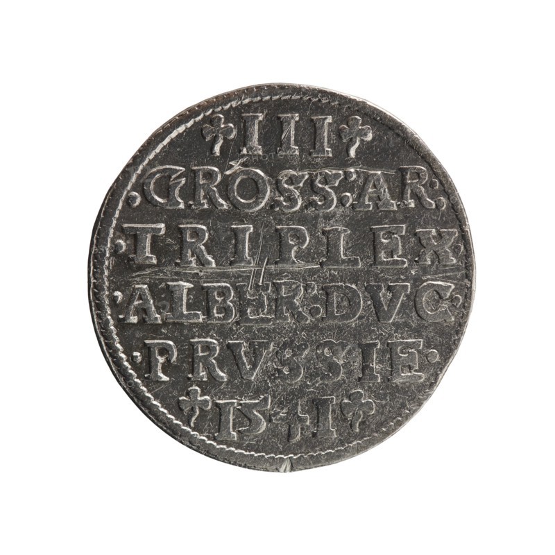 Trojak, Schilling, Maciej mintmaster; Decjusz, Jost Ludwik fl. 1528–1535 mint manager; co-creator. Albrecht Hohenzollern Prince of Prussia; 1490–1568 — iconography: trefoils, male busts in armour. Obverse: male bust in armour in profile turned right; short hair, long beard with sideburns. In the rim an inscription beginning with a trefoil: -ALBER DG MAR BRAN DVX PRVSS. Pearl border, plant motifs between the words. Reverse: in the pearl border an inscription in six lines: -III-.GROSS:AR:/.TRIPLEX./.ALBER:DVC./.PRVSSIE./-I54I-. The denomination and date are between trefoil marks. 1541. Ducal Prussia 1525–1701. Königsberg mint. Coin; diameter 22.7 mm; weight 2.48 g; axis 45°., A round metallic object with a weathered silver-gray surface, showing raised decorative ridges and stamped indentations across its face; the edge is slightly irregular with a textured border and small chips; the central area has a series of horizontal grooves and worn scratches, and there are a few small decorative ...