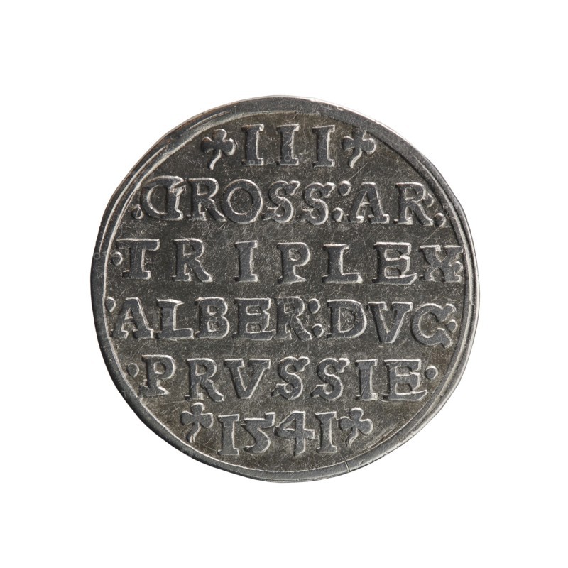 trojak; Schilling, Maciej mintmaster; Decjusz, Jost Ludwik fl. 1528–1535 co-creator; Albrecht Hohenzollern Prince of Prussia; 1490–1568 — iconography: male busts in armour, stars. Obverse: male bust in armour in profile turned right; short hair, beard with sideburns. Inscription around the rim: *ALBER DG MAR BRAN DVX PRVSS. Double continuous border, floral motifs between the words. Reverse: in the continuous border an inscription in six lines: -III-.GROSS:AR:/.TRIPLEX./.ALBER:DVC./.PRVSSIE./-I54I-. Denomination and date between trefoil marks. 1541. Ducal Prussia 1525–1701, Königsberg mint. Coin; diameter 22.3 mm, weight 2.57 g, axis 45°., A round metallic coin with a textured surface, showing a raised rim and carved, blocky raised shapes arranged in horizontal lines across the face. The coin appears primarily silver-gray with darker gray recessed areas and lighter silver highlights on the raised details. The edge shows slight irregularities and wear, and the overall surface has small s...