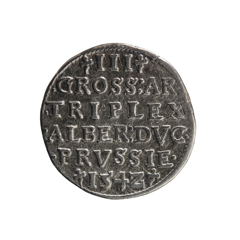 Trojak; Straub Strawb, Heinrich mintmaster/publisher; Decius, Jost Ludwik fl. 1528–1535 co-creator/mint manager. Obverse: male bust in armour in profile facing right; short hair, long beard with sideburns. In the rim an inscription beginning with a trefoil: -ALBER DG MAR BRAN DVX PRVSS; pearl border, plant motifs between words. Reverse: in the pearl border an inscription in six lines: -III-.GROSS:AR:/.TRIPLEX./.ALBER:DVC./.PRVSSIE./-I54Z- denomination and date between trefoil marks. Date: 1542. Place: Ducal Prussia, Königsberg mint. Coin; diameter 21.2 mm; weight 2.39 g; axis 135°., A round metallic object with a worn textured surface showing raised design elements and indented areas, appearing in shades of silver, gray, and dark gray, with slight darker tarnishing around the edges and within crevices; the object has an uneven rim and scattered fine scratches and dents, and it sits against a plain white background.