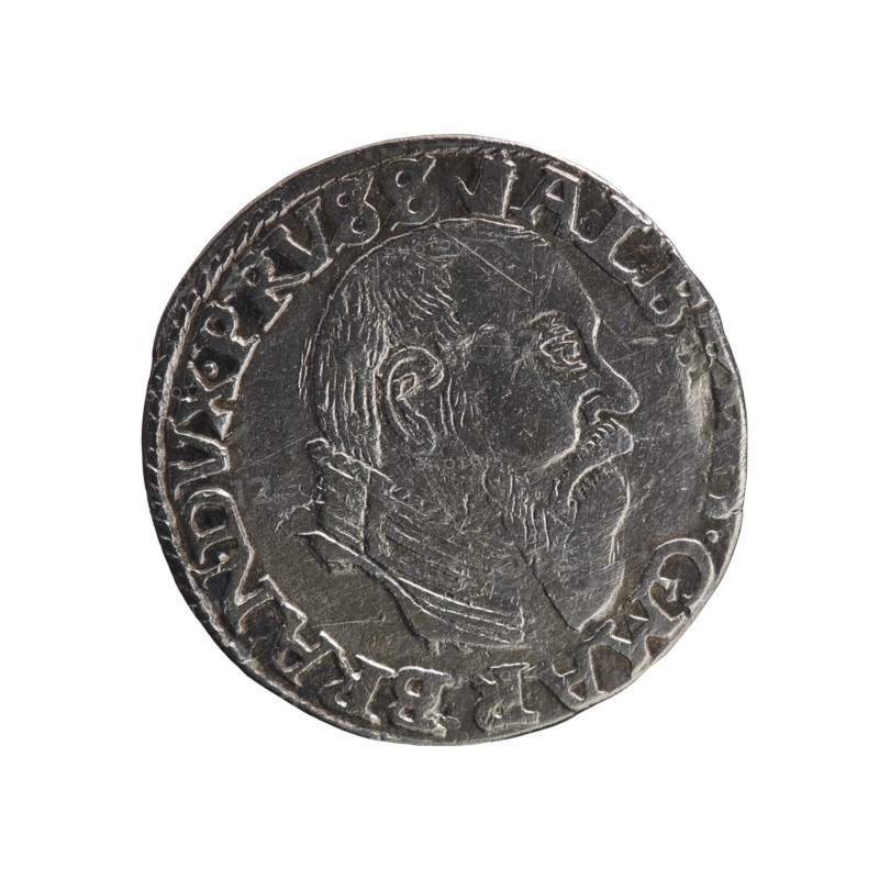 trojak, Albrecht Hohenzollern Prince of Prussia; 1490–1568 - iconography: towers, male busts in armor. Obv.: male bust in armor in profile turned to the right; short hair, long pointed beard with sideburns. In the rim an inscription beginning with a tower - ALBE... G.MAR.BRAN.DVX.PRVSS; pearl border. Rv.: in the pearl border an inscription in six lines: +III+/GROSS:AR./.TRIPLEX/.ALBER.DVC/PRVSSIE./+I558; denomination and date between lilac crosses, 1558. Duchy of Prussia 1525–1701, Königsberg mint. Coin: diameter 21.4 mm, weight 2.52 g, axis 140°., A round metallic coin with a worn surface showing a raised profile of a man's head facing right, featuring a beard and short hair and wearing a high-collared garment; the coin's rim has a raised border and a continuous ring of embossed decorative elements around the portrait; the metal appears silver-gray with darker gray areas in the recessed parts and lighter silver highlights on the raised details.