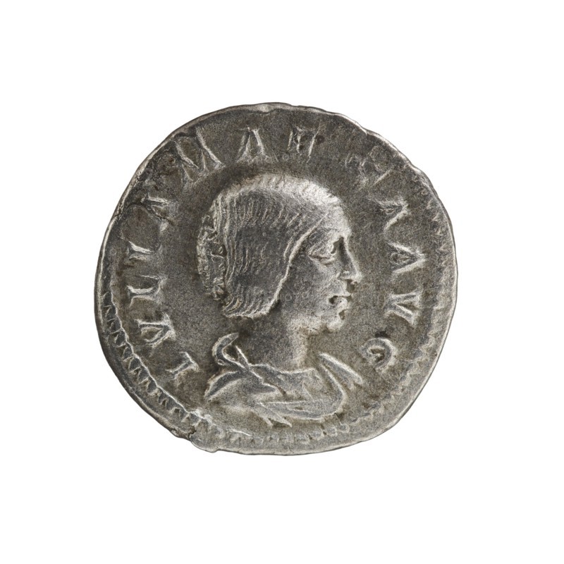 Denarius, Elagabalus 204–222; Roman emperor 218–222. Obv.: IVLIA MAESA AVG — Draped bust of Julia Maesa facing right, pearl border. Rev.: SAECVLI FELICITAS — Felicitas standing left, holding a patera above a burning altar in her right hand and a long caduceus in her left; star in right field, pearl border. Rome, 218–223. Coin; diameter c. 18.5–19.0 mm; weight 2.95 g., A circular metallic coin with a worn, textured surface showing a raised profile of a person facing right with short hair and a visible ear, shoulders, and draped clothing; the coin edge is irregular and slightly dented in places, and there is a ring of raised markings around the central portrait; visible colors include silver, gray, and darker gray tones.