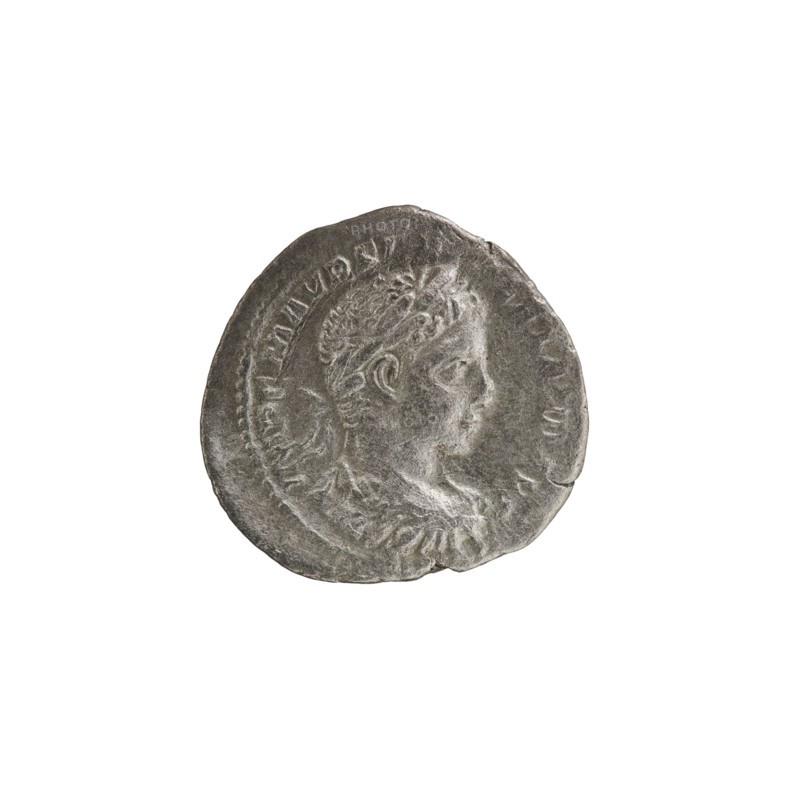 Denarius; Roman deities; Jupiter; Alexander Severus Roman emperor, 222–235 — iconography. Obverse: IMPCMAVRSEVALEXANDAVG — Bust of Alexander Severus with laurel wreath and paludamentum facing right; pearl rim. Reverse: IOVICONSERVATORI — Jupiter naked with a cloak standing facing left, holding a thunderbolt in his right hand and a long scepter in his left; pearl rim. 222–228. Roman Empire. Mint: Rome. Coin; diameter 18.5–19.5 mm; weight 2.65 g., A round metallic coin with a worn, textured surface showing a raised profile of a person's head in relief facing right, surrounded by a decorative raised rim and faint raised markings around the edge; the coin appears primarily silver-gray with darker gray shadows in the recesses and slight lighter gray highlights on the raised areas.