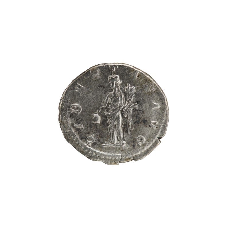 Denarius, Alexander Severus Roman emperor; 222–235 — Obv.: IMPCMAVRSEVALEXANDAVG. Bust of Alexander Severus wearing a laurel wreath, armor, and paludamentum facing right; pearl border. Rev.: LIBERTASAVG. Libertas standing, head left, holding a pileus in his right hand and a cornucopia in his left; pearl border. 222–228. Roman Empire. Rome. Coin; diameter ca. 17.5–19.0 mm; weight 2.90 g., A circular metallic object with a worn, uneven edge sits against a white background; the surface shows a raised, low-relief figure of a standing person draped in long robes, holding something long and branch-like in one hand and a small object in the other, with areas of darker tarnish and lighter silver-gray highlights across the patina.