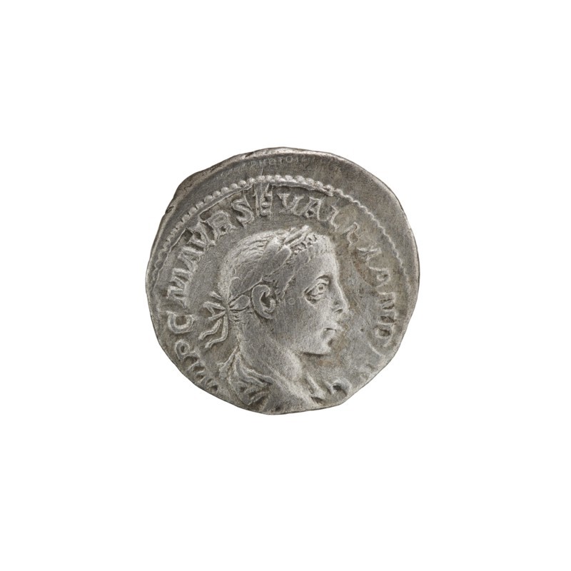 Denarius; obverse: bust of Alexander Severus Roman emperor, 222–235 with laurel wreath and paludamentum facing right, pearl rim, inscription IMPCMAVRSEVALEXANDAVG. Reverse: SALVSPVBLICA; Salus seated facing left, holding a patera in her right hand feeding a snake coiled around an altar, left hand on the backrest, pearl rim. Roman Empire, Rome, 222–228. Coin, diameter 18.5–19.0 mm, weight 3.45 g., A circular metallic object with a worn, uneven edge showing a raised profile of a person's head in relief facing right, with short hair and a tied ribbon at the back, set against a textured background and surrounded by a raised border; the object is mainly silver-gray with darker gray shadows and slight brownish-gray discoloration in some areas.