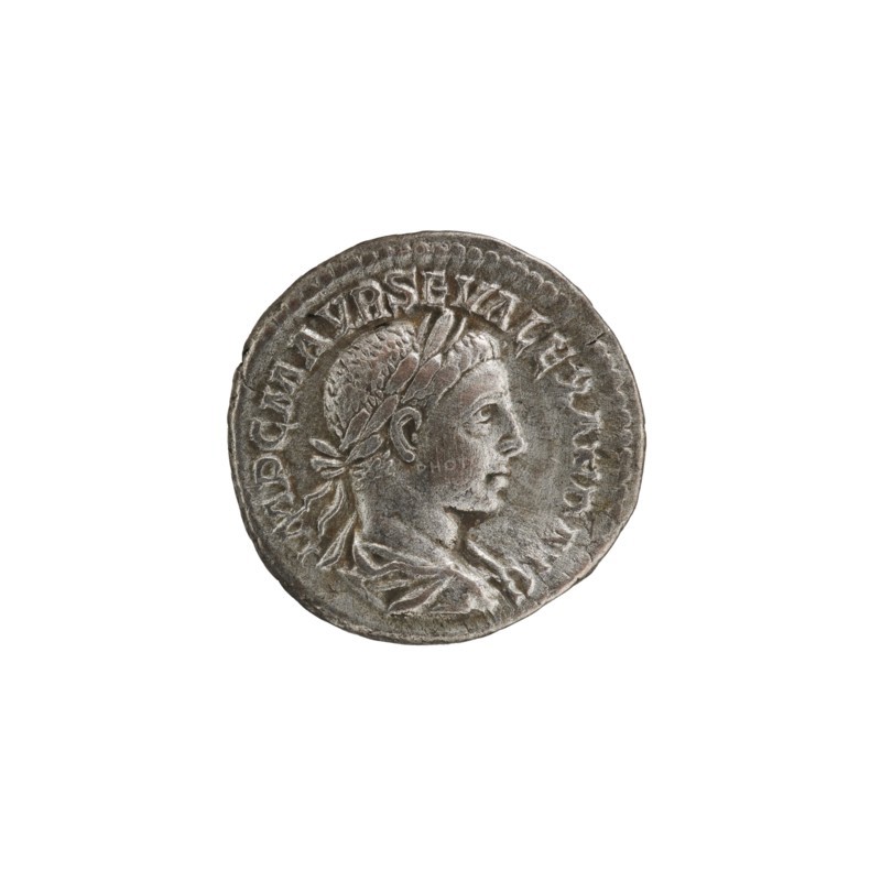 Denarius, personifications, Alexander Severus Roman emperor; 222–235 - iconography, Salus personification. Obv.: IMPCMAVRSEVALEXANDAVG. Bust of Alexander Severus with laurel wreath and paludamentum facing right, pearl rim. Rev.: PMTRPII COSPP. Salus seated on a throne facing left, in his right hand holding a patera feeding a snake coiled around the altar, left elbow resting on the back of the throne, pearl rim. 222. Roman Empire 27 BC–476, Rome. Coin: diameter 19.0–19.5 mm, weight 3.60 g., A round metallic coin with a raised profile of a person facing right wearing a laurel wreath and draped clothing, shown against a plain white background; the coin surface appears worn and textured with areas of darker and lighter gray and hints of brown patina.