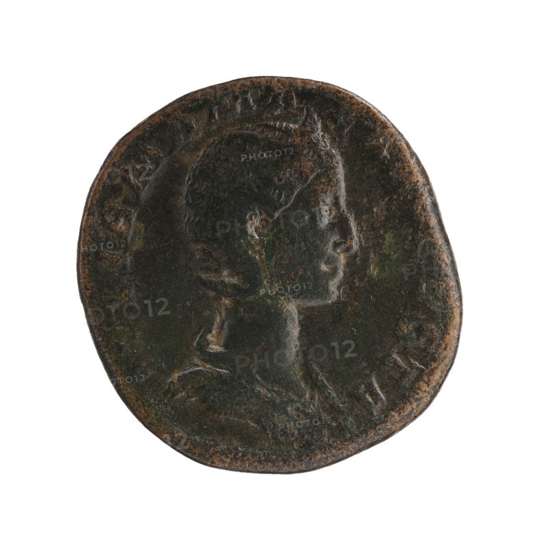 Sestertius depicting Julia Mamaea ca. 180–235 and Alexander Severus 208–235; Roman emperor 222–235. Obverse: portrait and imperial titles; reverse: Venus iconography. Date: 225–235. Roman Empire, Rome. Coin; bronze; diameters 26.5 mm and 29.0 mm; weight 17.85 g., A round, worn coin with a raised profile of a person's head facing right, showing short hair and a defined neck and shoulders, rendered with shallow relief and smooth contours; the coin's surface has areas of dark greenish-brown patina with patches of rusty brown and subtle black tones, and the rim appears uneven and slightly irregular.