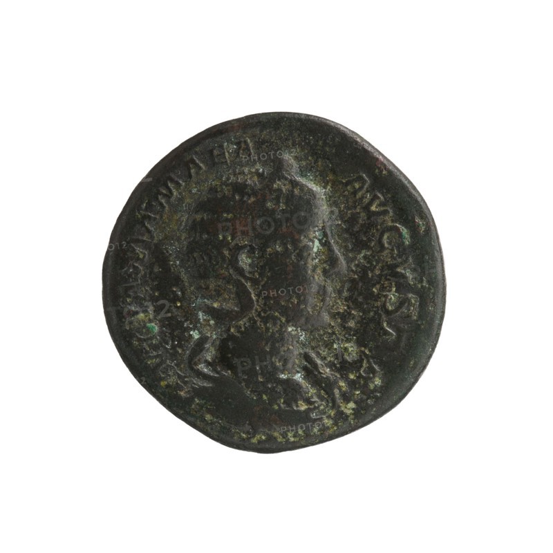 Julia Mamaea ca. 180–235; Augusta 222–235 co-creator; Alexander Severus 208–235; Roman emperor 222–235 issuer; Roman deities — Vesta myth.; iconography: Julia Mamaea 180–235; date: 225–235, Rome; Roman Empire 27 BC–476; coin; diameter 24.0–25.0 mm; weight 9.73 g., A circular metal coin with a worn raised profile of a person in the center, showing a head and shoulders outline facing to the right; the surface has textured corrosion and patina with visible green and dark brown areas, along with patches of lighter brown and black; the coin edge is uneven and slightly irregular, and there are faint raised markings around the perimeter.