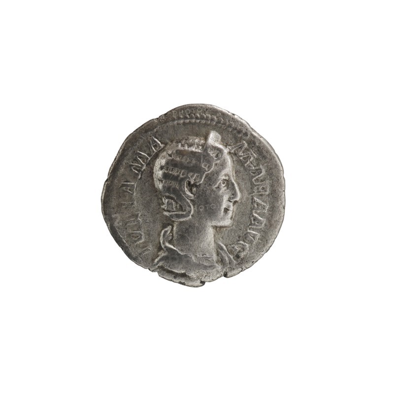 Denarius depicting Julia Mamaea ca. 180–235; Augusta 222–235 and Alexander Severus 208–235; Roman emperor 222–235; issuer: Alexander Severus. Obverse: portraits of Julia Mamaea and Alexander Severus. Reverse: Vesta Roman deity. Iconography of Julia Mamaea 180–235. Date: 225–235, Rome, Roman Empire 27 BC–476. Coin; diameter 18.5–19.0 mm; weight 2.25 g., A round metallic object with a worn surface and a raised profile of a person's head in relief, shown in side view facing right; the head has stylized hair and a visible ear, and the neck and upper shoulders are depicted with draped clothing. The object appears silver-gray with darker gray areas from wear and shadow, and there are subtle lighter silver highlights on raised edges. The rim of the object is irregular and slightly uneven, and the surface shows small pits and abrasions. The background is plain white.