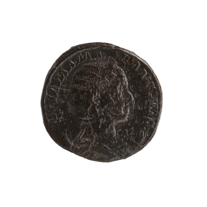 dupondius depicting Julia Mamaea ca. 180–235; Augusta 222–235 and Alexander Severus 208–235; Roman emperor 222–235; issuer Alexander Severus; personifications including Felicitas; iconography of Julia Mamaea; dated 222–235, Rome, Roman Empire 27 BC–476; coin, diameter 23.0–23.5 mm, weight 10.75 g, A round dark brown coin with a worn raised profile of a person's head in relief at its center, showing facial contours and textured hair or headwear; the coin's surface appears uneven and aged with lighter brown highlights and small shiny spots, and the rim is slightly irregular against a plain white background.