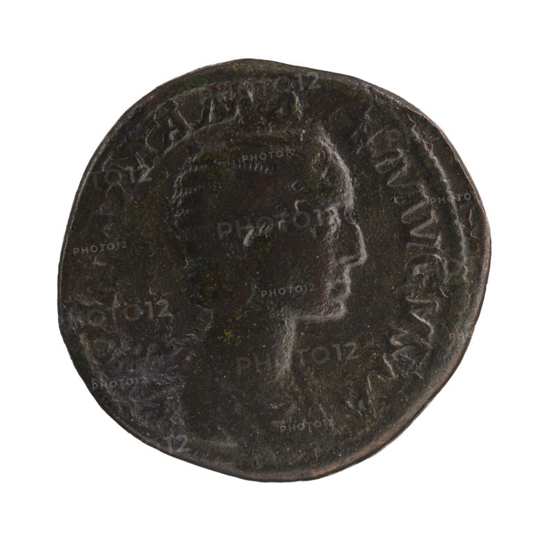 Sestertius depicting Julia Mamaea ca. 180–235 and Alexander Severus 208–235, Roman emperor 222–235; obverse/issuer: Alexander Severus; reverse: Felicitas personification and Julia Mamaea—iconography of personifications; date: 222–235 CE; place: Rome, Roman Empire; medium: coin sestertius; diameter: 29.5–32.0 mm; weight: 18.3 g., A round dark metal coin shown against a white background featuring a raised profile of a person facing right; the coin surface is uneven and worn with visible ridges and indentations, and there is a raised rim around the edge. The visible colors are dark brown, black, and hints of greenish patina.