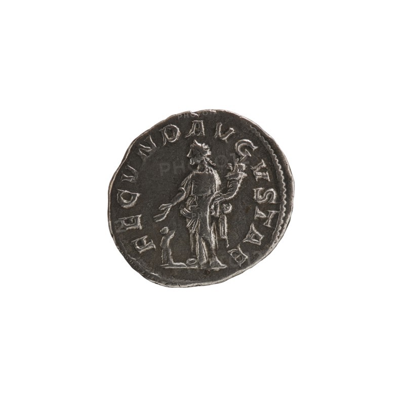Denarius, Julia Mamaea ca. 180–235; Augusta 222–235 co-creator; Alexander Severus 208–235; Roman emperor 222–235 issuer; personifications; Julia Mamaea 180–235 — iconography; Fecunditas personification; 225–235 CE; Roman Empire; Rome; coin; diameter 17.0 mm; diameter 19.0 mm; weight 2.70 g, A round metallic coin with a dark gray and silver surface sits against a white background, showing wear and raised edges; the coin features a raised profile of a standing figure in draped clothing holding an object, with a few decorative raised elements and a border of raised markings around the rim.