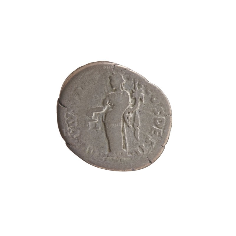 Denarius of Antoninus Pius 86–161; Roman emperor 138–161. Obverse: head of Antoninus Pius uncovered to the right; inscription IMP TAE L CAES HA DRI ANTONINVS all around. Reverse: Aequitas standing to the left, holding scales in his outstretched right hand and a cornucopia in his left; inscription AVG PIVS PM T R P COS DES II all around. Iconography: personifications; Aequitas with scales and cornucopia. Date: 138. Place: Rome, Roman Empire. Object type: coin denarius. Diameter: 15.0–19.5 mm; weight: 2.80 g; axis: 165°., A round coin with a worn surface showing a raised outline of a standing human figure and a smaller raised shape near the figure, all in shades of gray and silver with areas of darker gray patina and slight brownish tones along the edge.