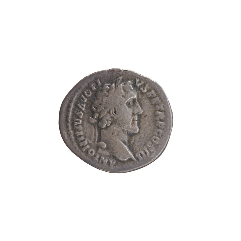 Denarius, Antoninus Pius 86–161; Roman emperor 138–161. Obverse: Head of Antoninus Pius with laurel wreath to the right, legend ANTONINVS AVG PI - VS PP TR P COS III. Reverse: Head of young Marcus Aurelius without a covering to the right, legend AVRELIVS CAESAR AVG PII F COS. Date: 140. Place of origin: Rome, Roman Empire. Medium: coin denarius. Diameter: 16.0–17.0 mm. Weight: 2.94 g. Axis: 210°., A round metallic object with a worn surface showing the profile of a person facing right, surrounded by raised edges and a ring of shallow markings; the object appears mostly gray with darker and lighter gray variations and subtle brownish tones.