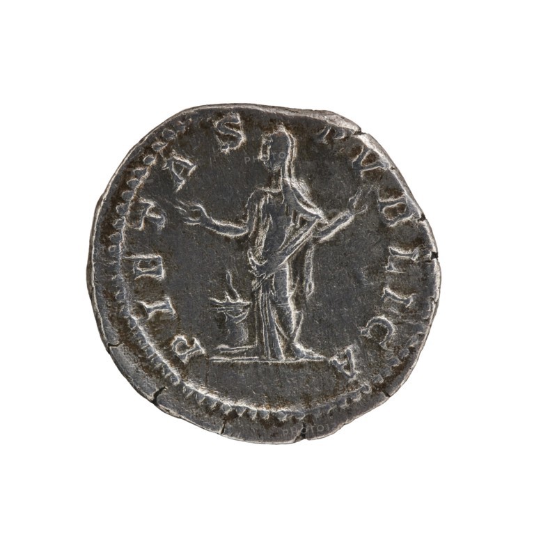 Denarius of Septimius Severus 146–211; Roman emperor 193–211. Issuer: Julia Domna ca. 160–217; Roman empress 193–211. Obverse: IVLIA AVGVSTA, bust of the empress facing right. Reverse: PIETAS PVBLICA, Pietas standing left in front of an altar with raised arms. Date: 196–211. Place of origin: Rome, Roman Empire. Type: coin denarius. Diameter: 17.5–18.5 mm. Weight: 3.08 g., A round metal coin with a dark gray to silvery surface showing wear and scratches, featuring a raised depiction of a standing human figure in draped clothing with arms extended and a small raised object near the figure’s feet; the coin edge is irregular and slightly chipped, with a contrast between darker recessed areas and lighter worn highlights.